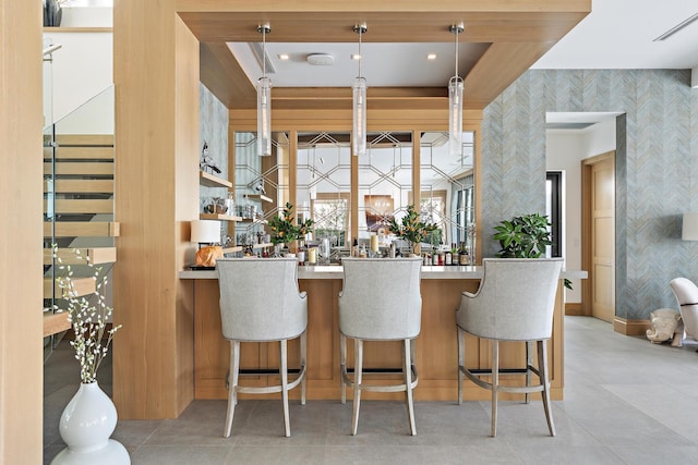 bar featuring hanging light fixtures