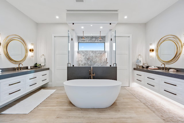 bathroom with shower with separate bathtub, wood-type flooring, and vanity