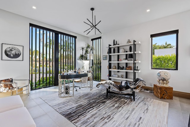 living area with light tile patterned floors and a notable chandelier