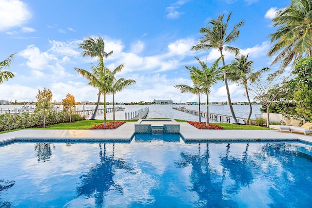 view of swimming pool featuring a water view and an in ground hot tub