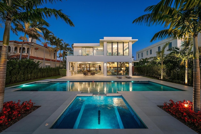 view of swimming pool featuring a patio area and an in ground hot tub