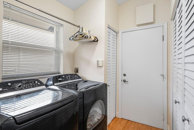 laundry area featuring washer and dryer and light wood-type flooring