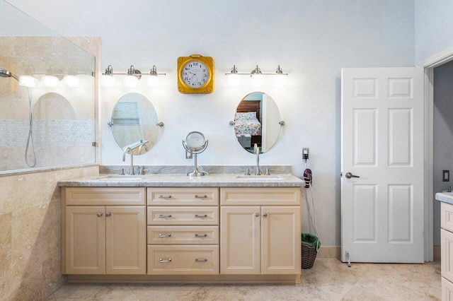 bathroom with tile patterned floors, vanity, and tile walls