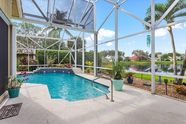 view of swimming pool featuring pool water feature, a lanai, a water view, and a patio