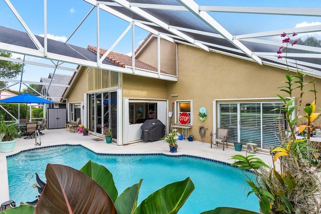 rear view of property featuring a lanai and a patio area