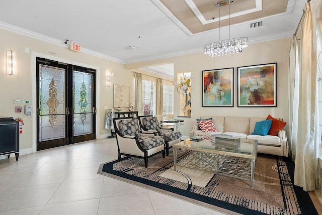 tiled living room with crown molding, french doors, and an inviting chandelier