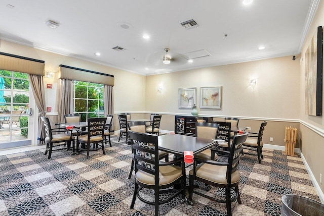 carpeted dining area featuring crown molding and ceiling fan