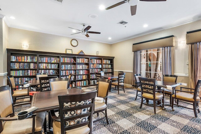 dining area featuring ceiling fan and ornamental molding