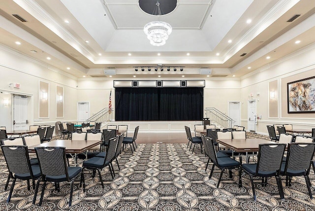 dining space featuring a tray ceiling, crown molding, a high ceiling, and a notable chandelier