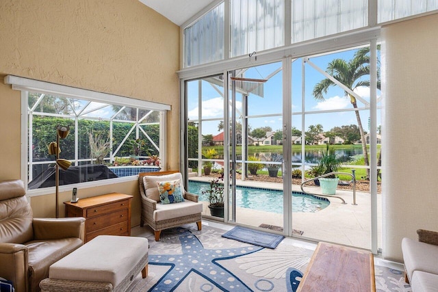 sunroom / solarium featuring a healthy amount of sunlight and a water view