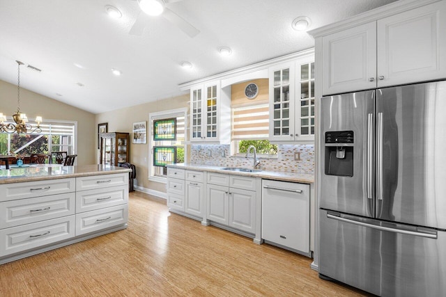 kitchen with dishwasher, sink, stainless steel fridge, light hardwood / wood-style floors, and white cabinets