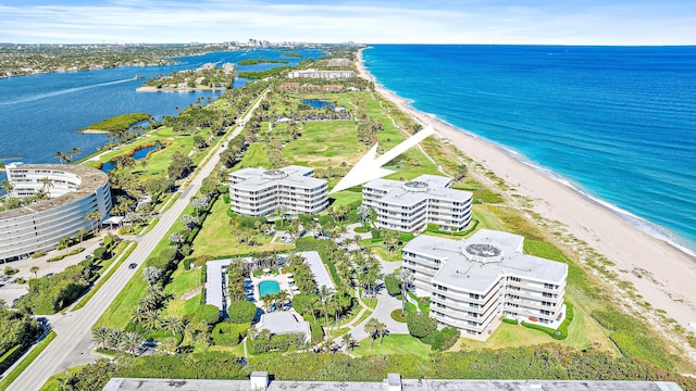 birds eye view of property featuring a beach view and a water view