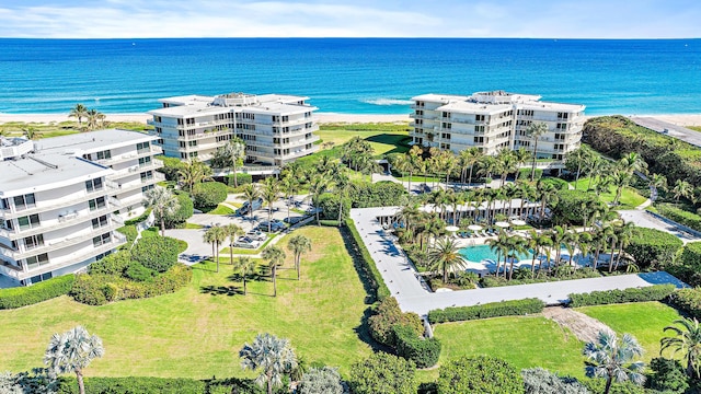 birds eye view of property with a water view and a view of the beach