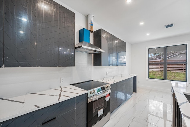 kitchen featuring wall chimney exhaust hood, light stone countertops, and stainless steel range with electric cooktop