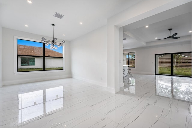 unfurnished dining area featuring ceiling fan with notable chandelier and plenty of natural light