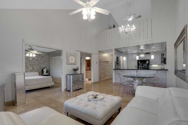 living room with light tile patterned floors, high vaulted ceiling, and a notable chandelier