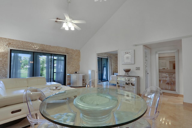 bedroom with ceiling fan, light tile patterned floors, and high vaulted ceiling