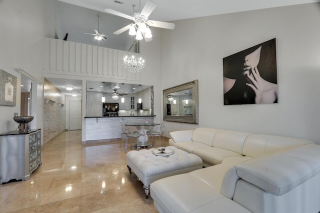 6136 SE Georgetown Pl, Hobe Sound, FL 33455 - living room with a ceiling fan, a towering ceiling, and a chandelier
