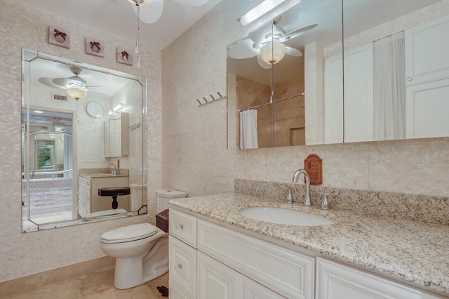6136 SE Georgetown Pl, Hobe Sound, FL 33455 - bathroom featuring ceiling fan, toilet, vanity, tile patterned flooring, and a shower with curtain