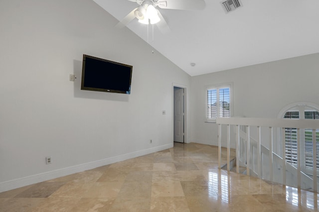 empty room featuring high vaulted ceiling and ceiling fan