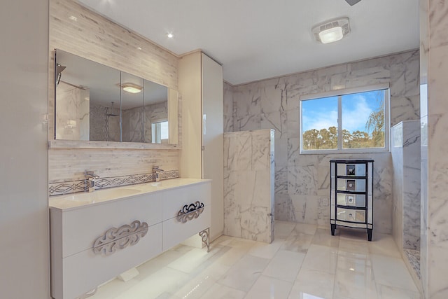 bathroom featuring vanity, tile walls, and walk in shower