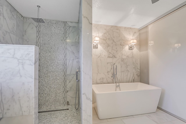 bathroom with tile walls and independent shower and bath