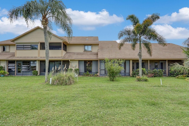 6136 SE Georgetown Pl, Hobe Sound, FL 33455 - rear view of house with a yard, roof with shingles, and a sunroom