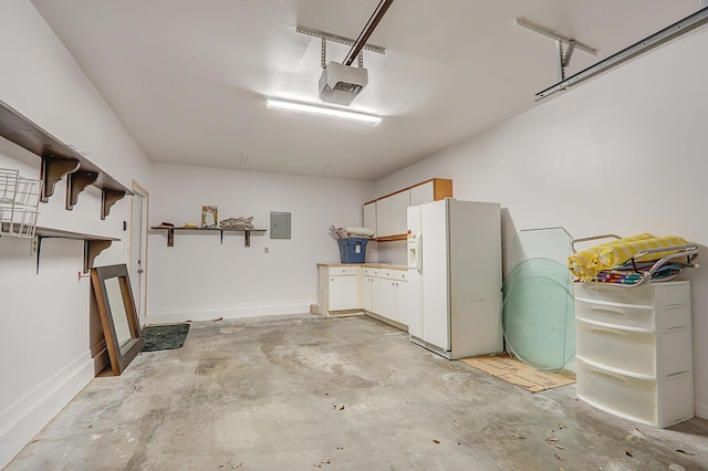 6136 SE Georgetown Pl, Hobe Sound, FL 33455 - garage featuring white fridge with ice dispenser, a garage door opener, electric panel, and baseboards
