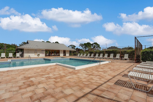 view of swimming pool with a patio area