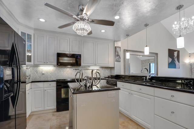 6136 SE Georgetown Pl, Hobe Sound, FL 33455 - kitchen featuring black appliances, dark countertops, ceiling fan, a center island, and a sink