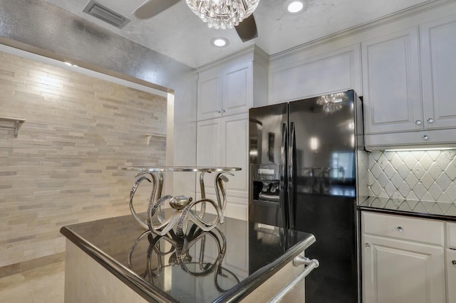 6136 SE Georgetown Pl, Hobe Sound, FL 33455 - kitchen featuring black fridge, a ceiling fan, dark countertops, recessed lighting, and white cabinetry
