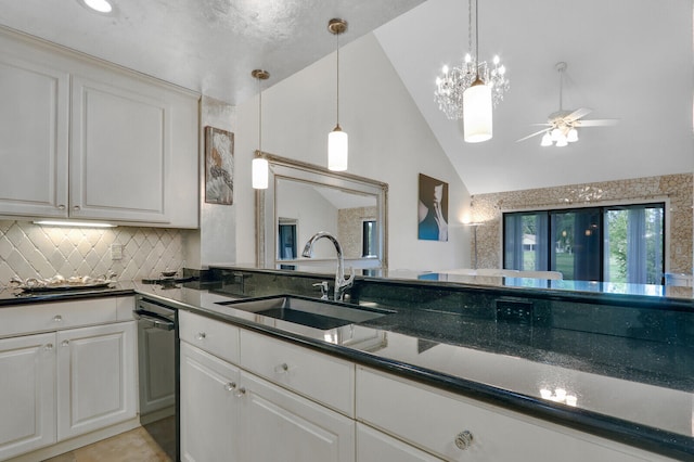 kitchen with white cabinets, ceiling fan with notable chandelier, lofted ceiling, and sink