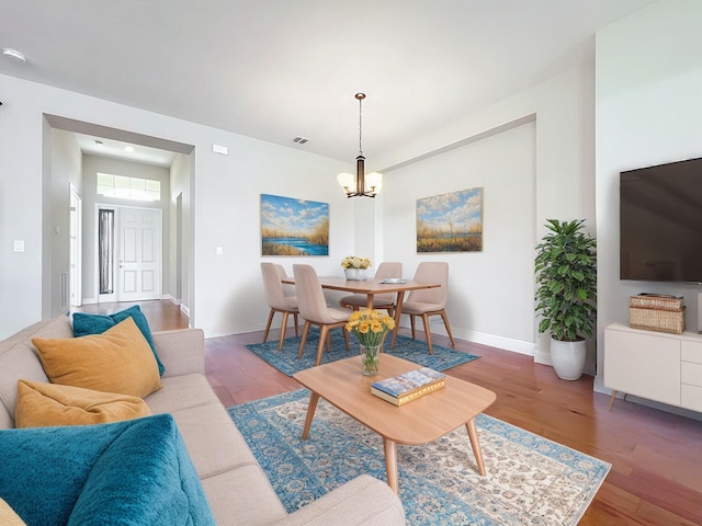 living room featuring a notable chandelier and hardwood / wood-style flooring