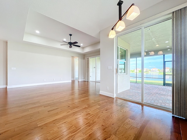 unfurnished room with hardwood / wood-style flooring and ceiling fan