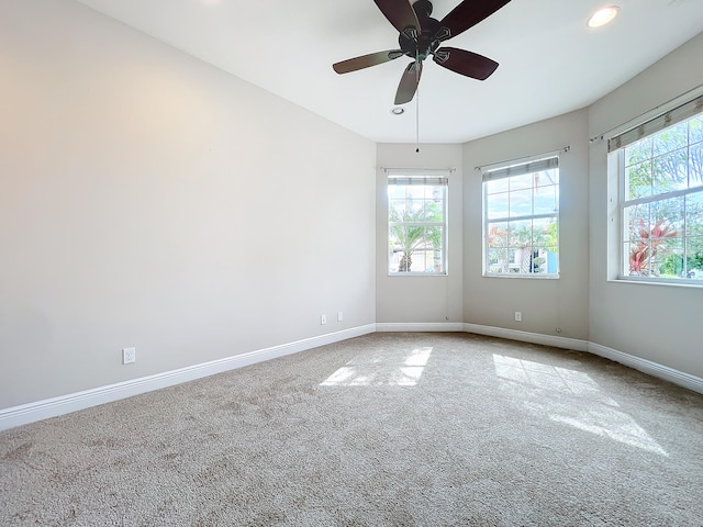 empty room with carpet flooring and ceiling fan