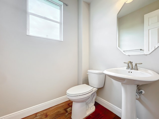 bathroom with hardwood / wood-style floors and toilet