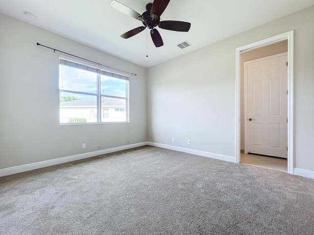 carpeted spare room with ceiling fan