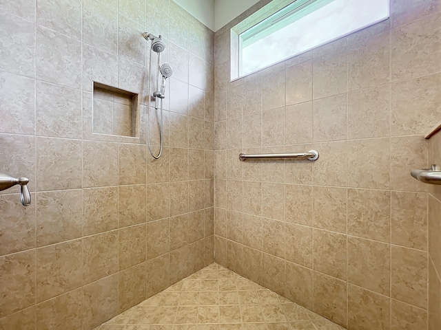 bathroom with a tile shower