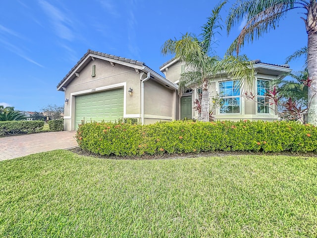 view of front of property featuring a garage and a front yard