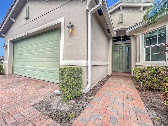 doorway to property with a garage