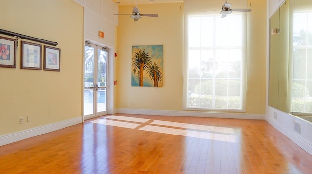 unfurnished room featuring light hardwood / wood-style floors and plenty of natural light