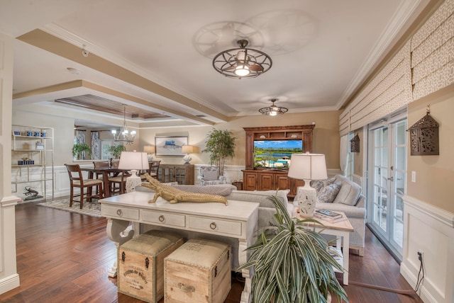 living room featuring french doors, crown molding, dark hardwood / wood-style flooring, and ceiling fan with notable chandelier