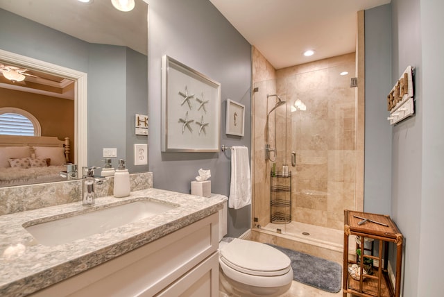 bathroom with vanity, a shower with shower door, and toilet