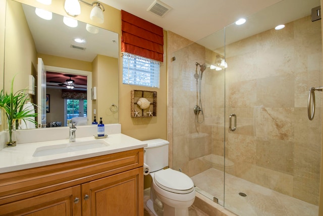 bathroom featuring ceiling fan, toilet, an enclosed shower, and vanity