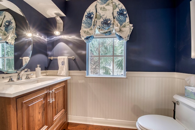 bathroom featuring hardwood / wood-style flooring, vanity, and toilet