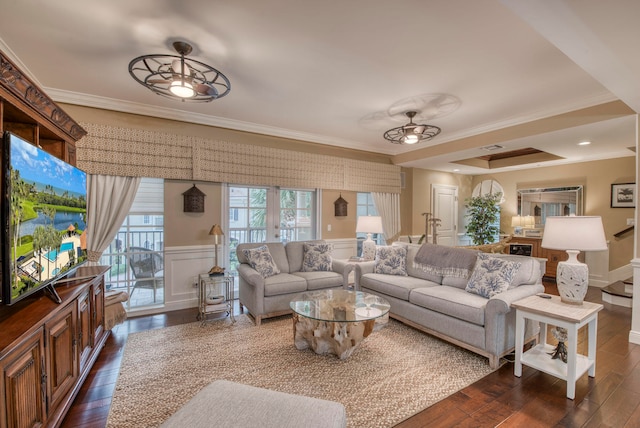 living room with dark hardwood / wood-style flooring, ceiling fan, and crown molding