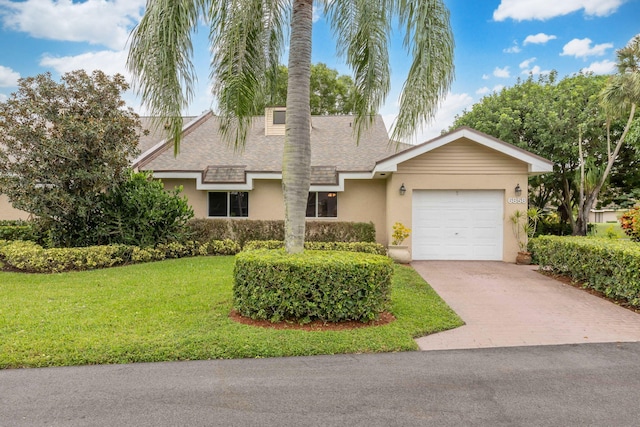 view of front of house featuring a garage and a front yard