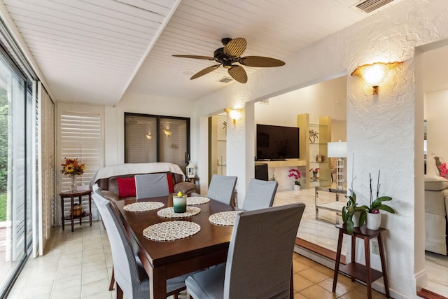 dining room with ceiling fan, light tile patterned floors, and wooden ceiling