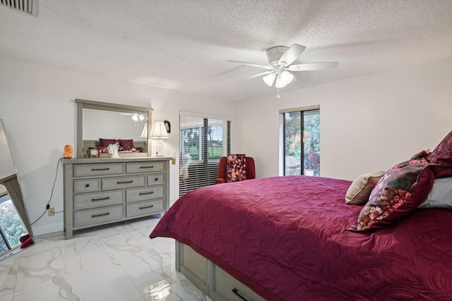 bedroom featuring access to exterior, ceiling fan, and a textured ceiling