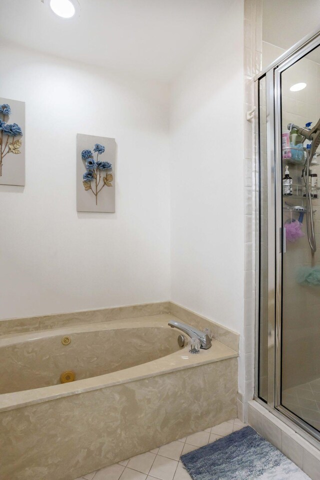 bathroom featuring tile patterned floors and independent shower and bath